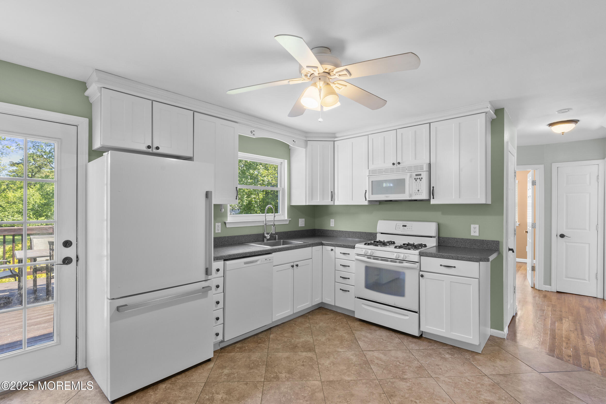 18 Hampton Road Howell, NJ 07731 - Photo 8 of 32 a white refrigerator freezer sitting inside of a kitchen with stainless steel appliances granite countertop a refrigerator a sink a stove and white cabinets