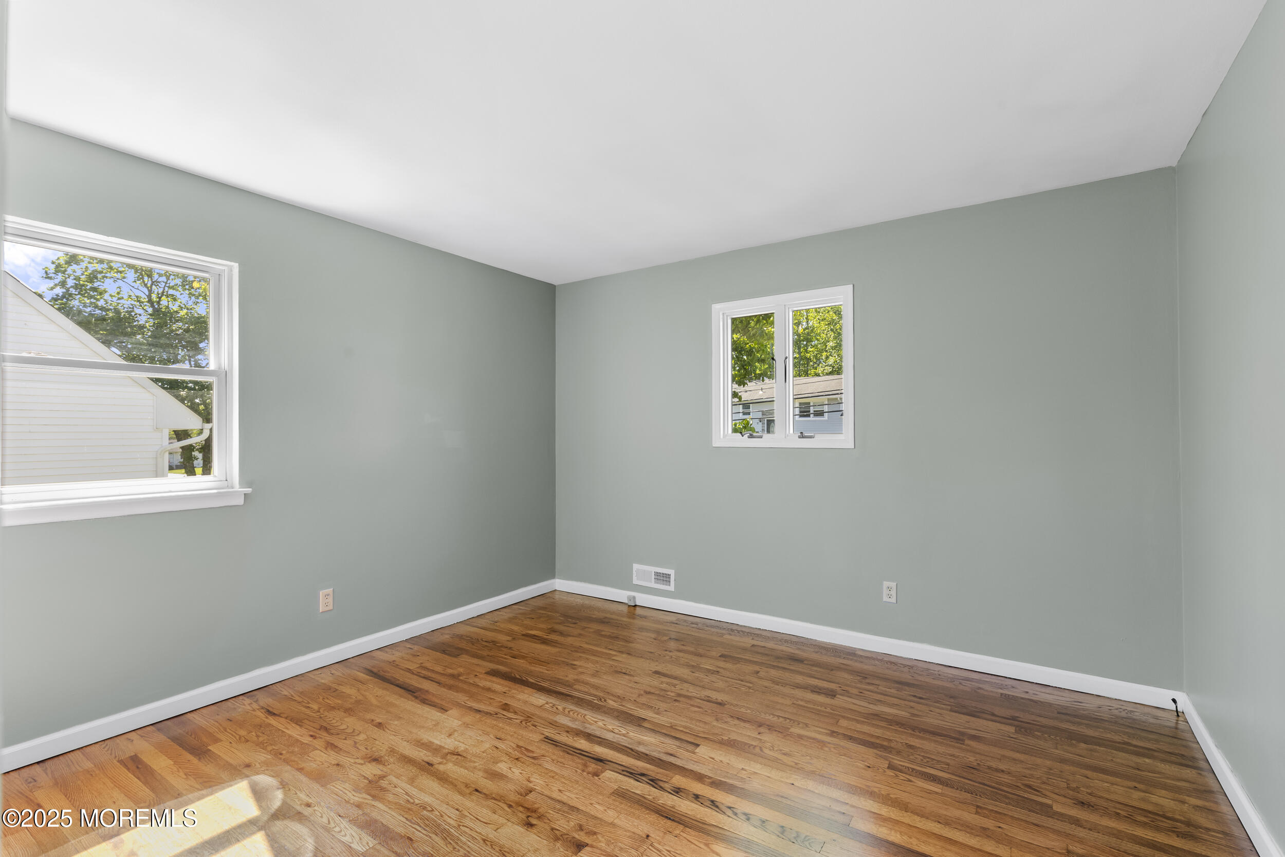 18 Hampton Road Howell, NJ 07731 - Photo 10 of 32 a view of empty room with wooden floor and fan