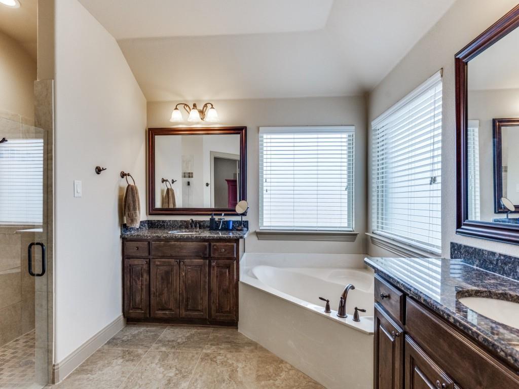 519 Gene Autry Lane Murphy, TX 75094 - Photo 16 of 25 Full bath with a stall shower, two vanities, a garden tub, and vaulted ceiling