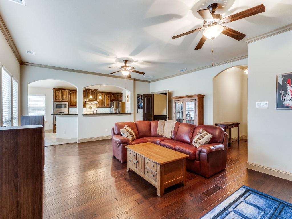 519 Gene Autry Lane Murphy, TX 75094 - Photo 5 of 25 Living room with arched walkways, crown molding, hardwood / wood-style flooring, and ceiling fan