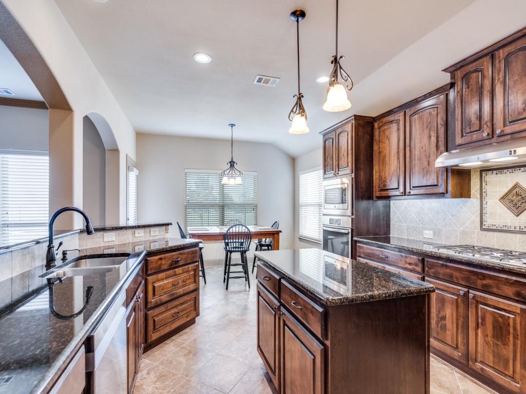 519 Gene Autry Lane Murphy, TX 75094 - Photo 10 of 25 Kitchen featuring tasteful backsplash, decorative light fixtures, dark stone counters, recessed lighting, and lofted ceiling