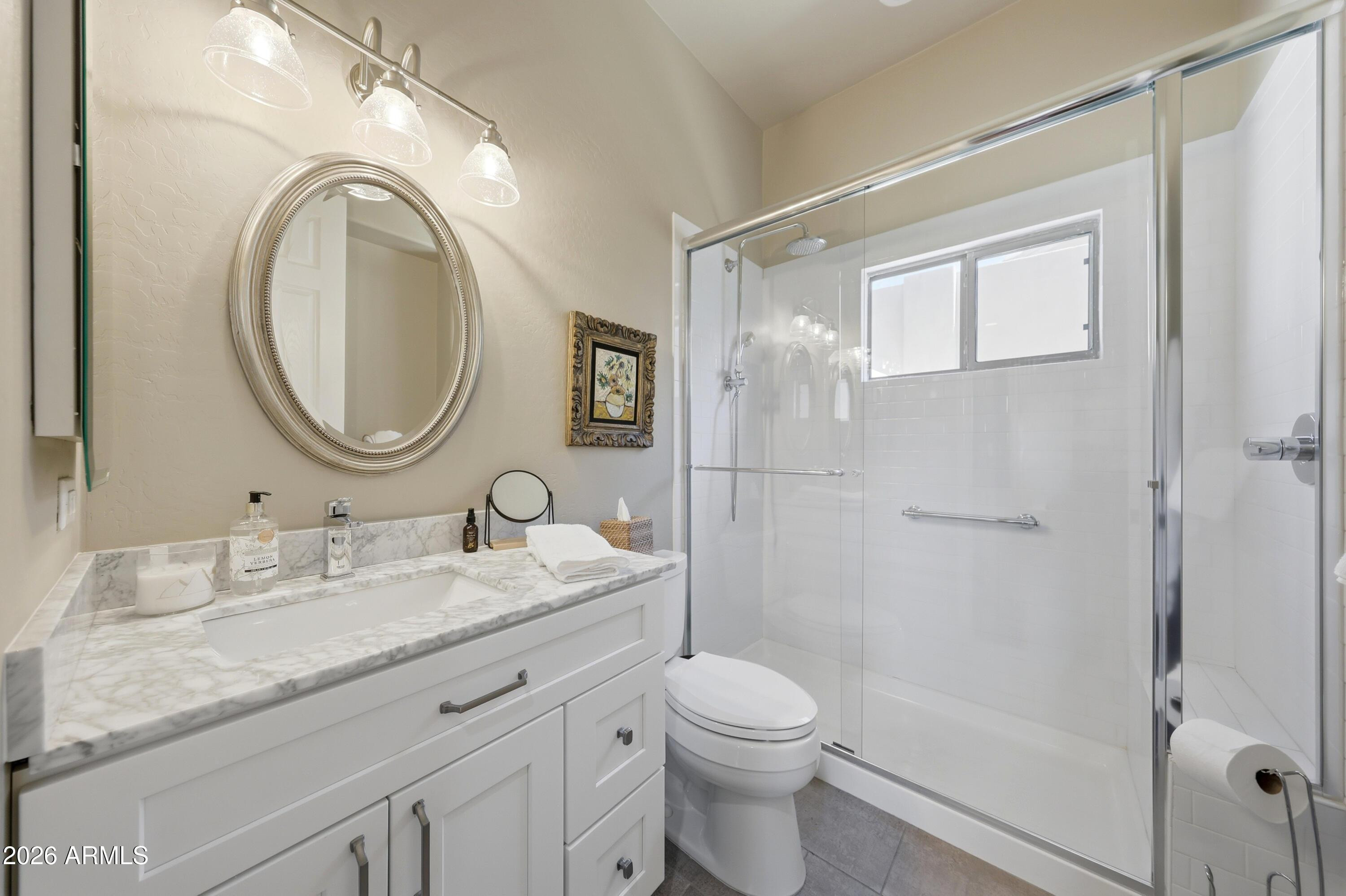 11071 East Evans Road Scottsdale, AZ 85255 - Photo 18 of 35 a bathroom with a granite countertop toilet a sink and a mirror