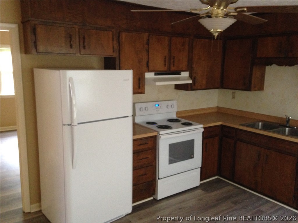 608 Bee Gee Road Lumberton, NC 28358 - Photo 3 of 8 a kitchen with a refrigerator stove and cabinets