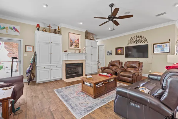 a living room with furniture a fireplace and a flat screen tv