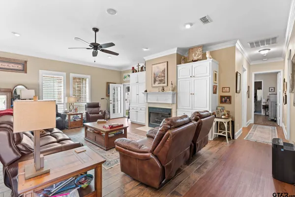a living room with furniture a fireplace and wooden floor