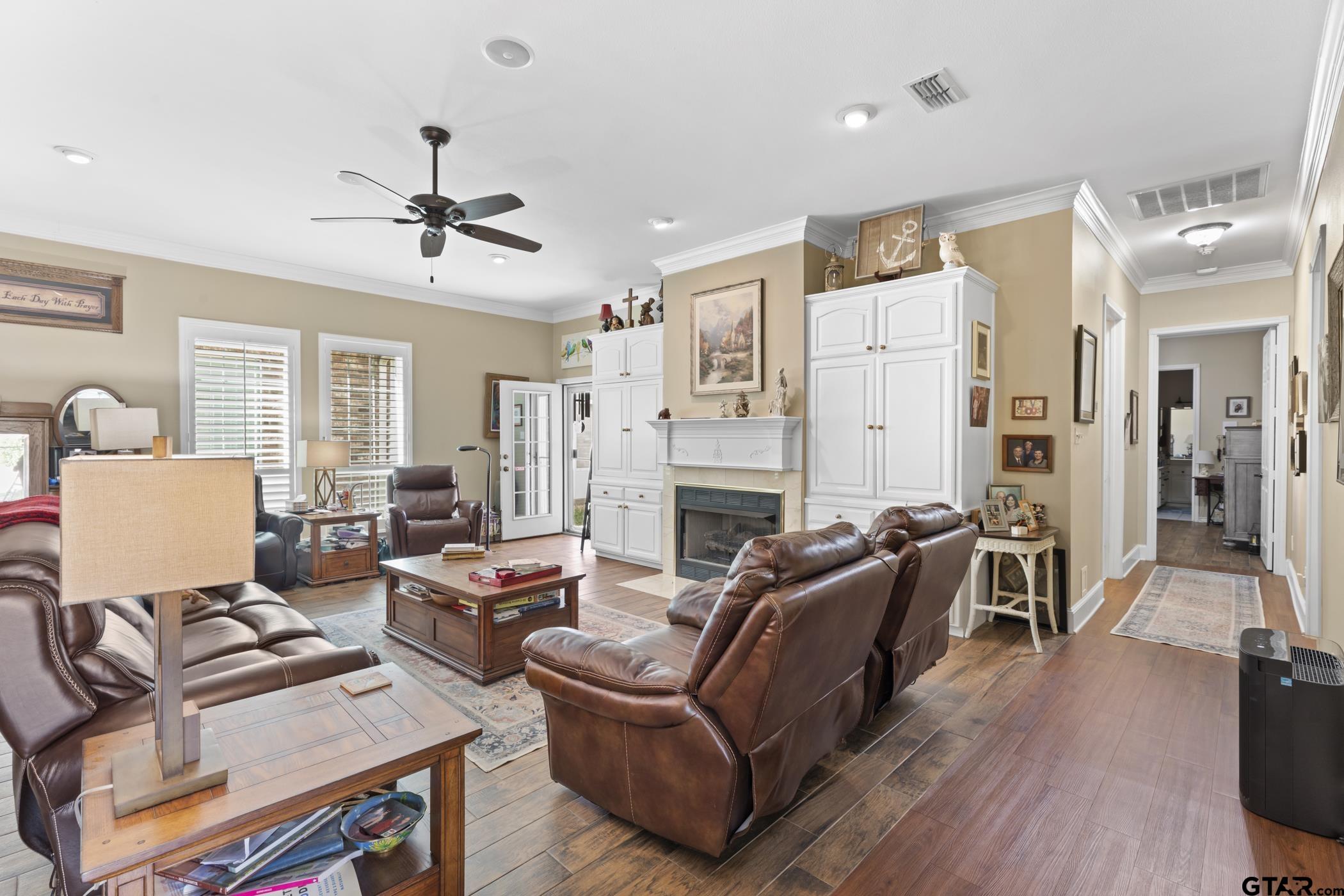 2315 Homestead Lane Tyler, TX 75701 - Photo 12 of 20 a living room with furniture a fireplace and wooden floor