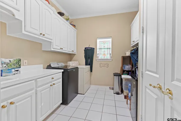 a kitchen with white cabinets and appliances