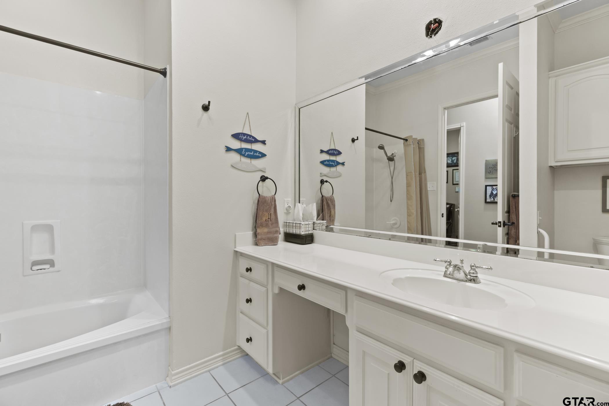 2315 Homestead Lane Tyler, TX 75701 - Photo 16 of 20 a bathroom with a tub sink and mirror