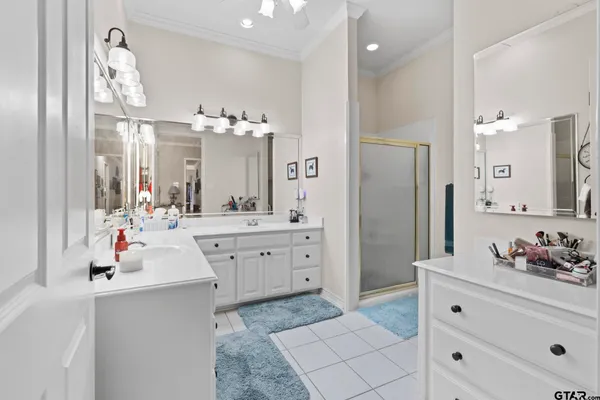 a spacious bathroom with a double vanity sink mirror and shower