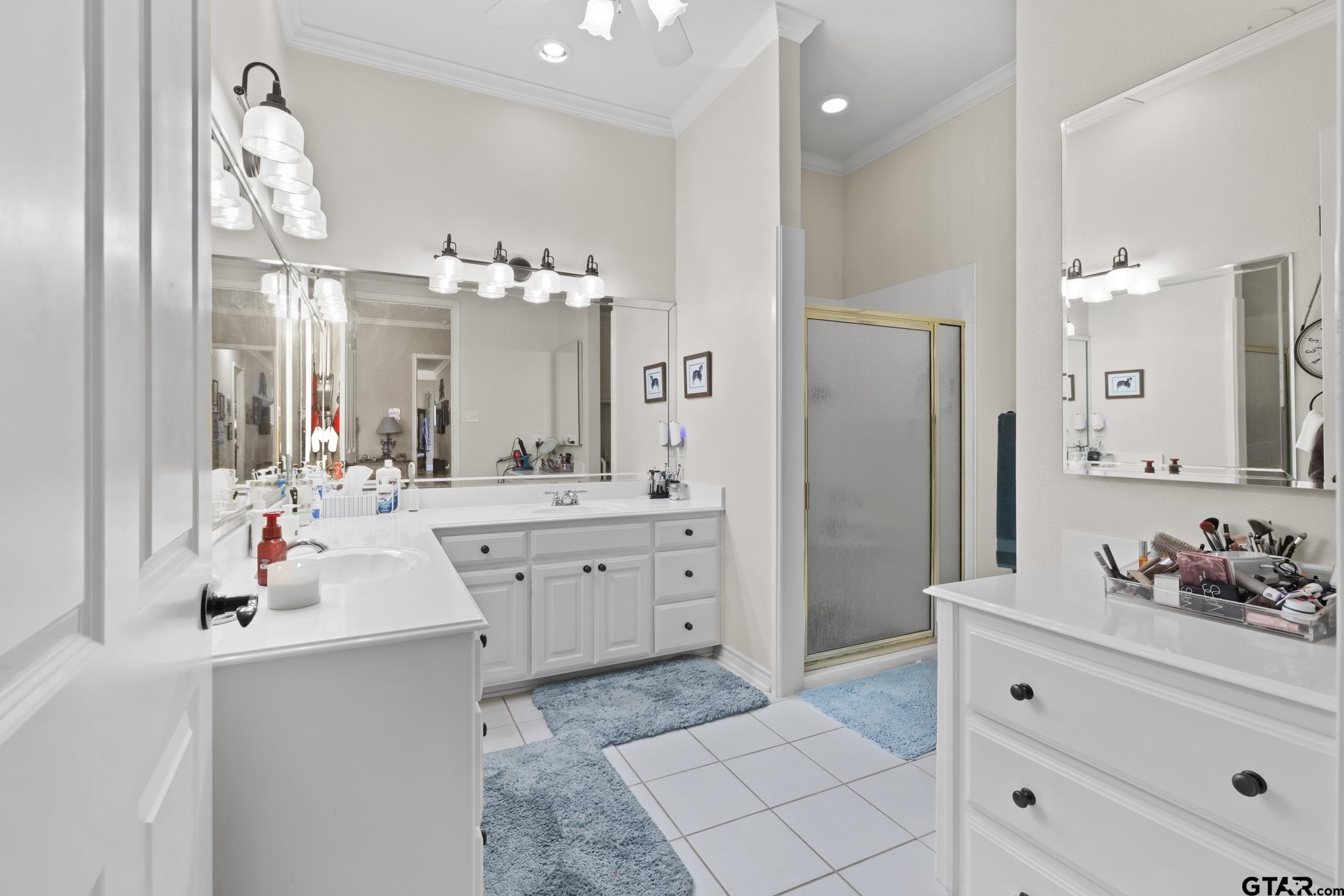 2315 Homestead Lane Tyler, TX 75701 - Photo 18 of 20 a spacious bathroom with a double vanity sink mirror and shower