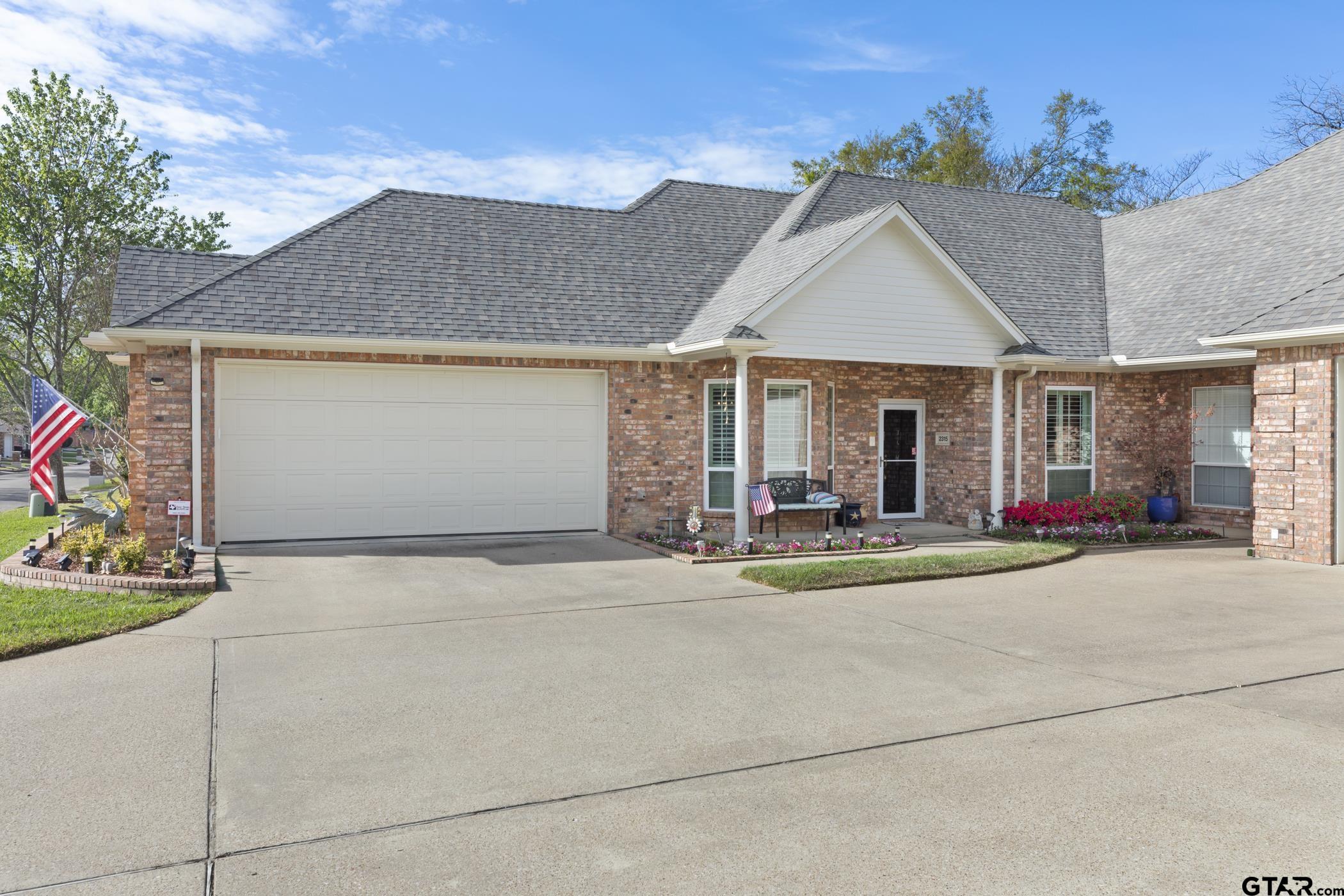 2315 Homestead Lane Tyler, TX 75701 - Photo 3 of 20 a front view of a house with a yard and garage