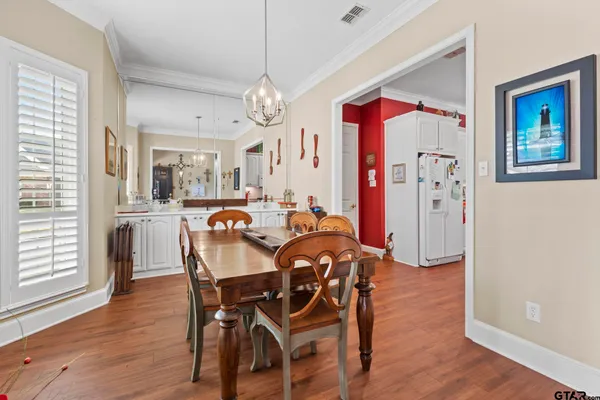 a view of a dining room with furniture wooden floor and chandelier