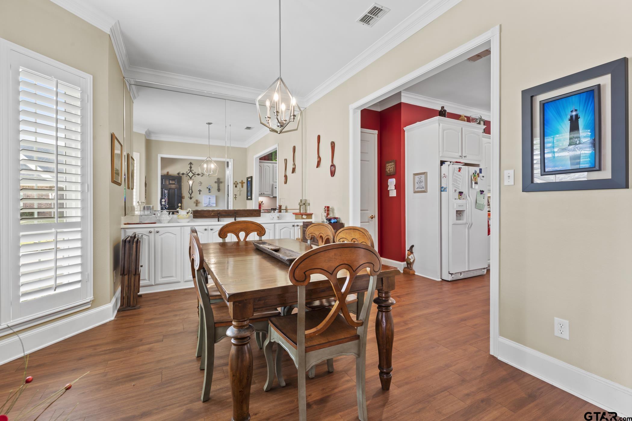 2315 Homestead Lane Tyler, TX 75701 - Photo 7 of 20 a view of a dining room with furniture wooden floor and chandelier