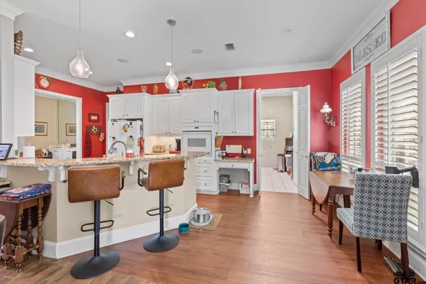 a living room with furniture and kitchen view