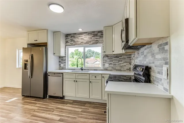 a kitchen with a sink stove and refrigerator