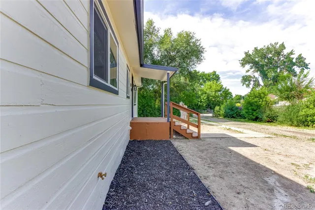 a view of a patio with table and chairs