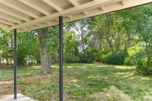 a view of a house with yard and a garden