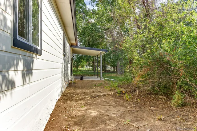 a view of a house with a tree in the yard