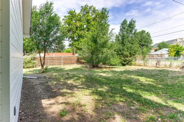 an aerial view of a house with a yard and garden