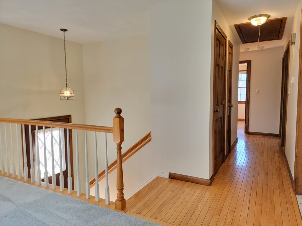 119 Cordaville Road Ashland, MA 01721 - Photo 20 of 32 a view of a hallway with wooden floor and staircase