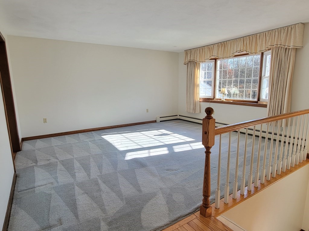 119 Cordaville Road Ashland, MA 01721 - Photo 7 of 32 a view of a livingroom with wooden floor and a window