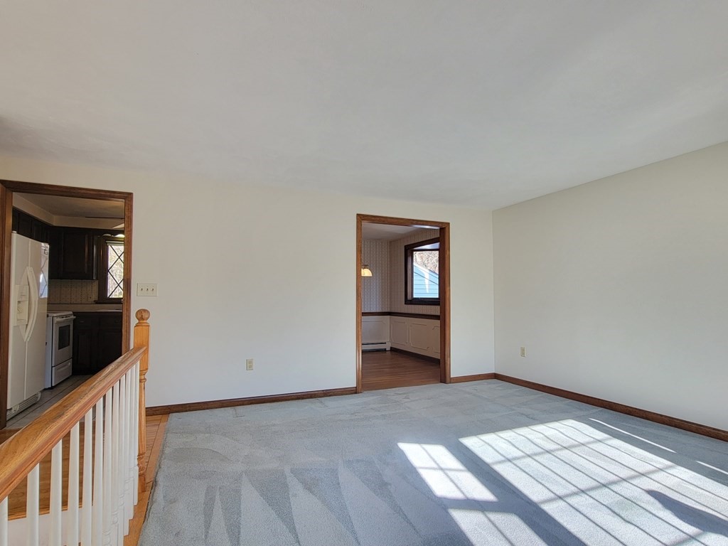 119 Cordaville Road Ashland, MA 01721 - Photo 10 of 32 a view of a livingroom with wooden floor and kitchen