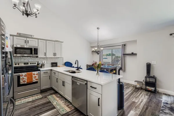 a kitchen with a sink stove and microwave