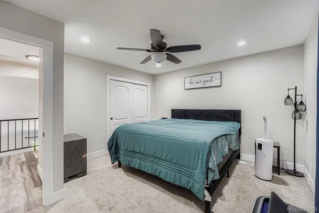a bedroom with a bed and a ceiling fan