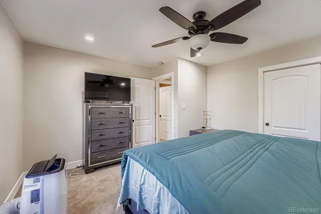 a bedroom with a bed and a television