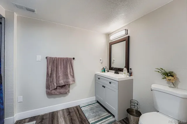 a bathroom with a sink toilet and mirror