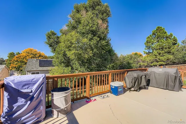 a view of a chair and table on the roof deck