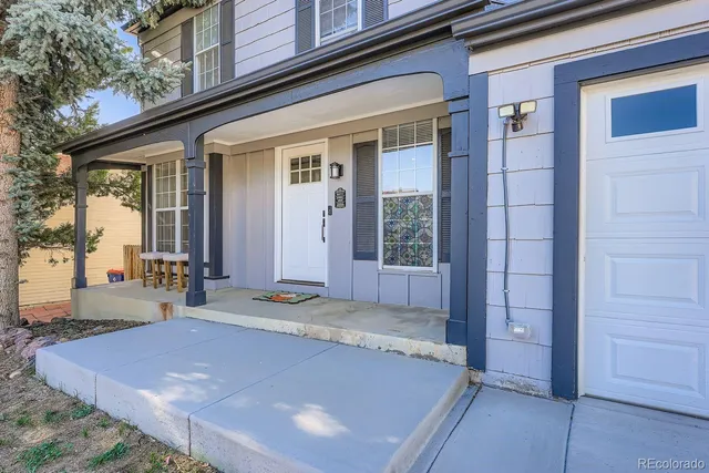 a view of an house with swimming pool and porch
