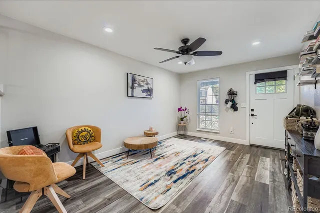 a living room with furniture and a wooden floor