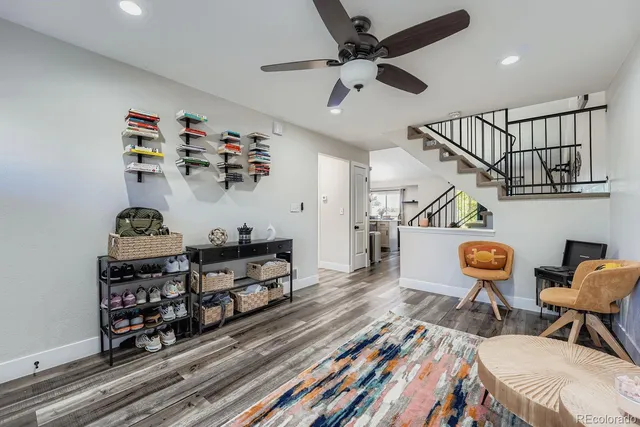 a living room with lots of furniture and wooden floor