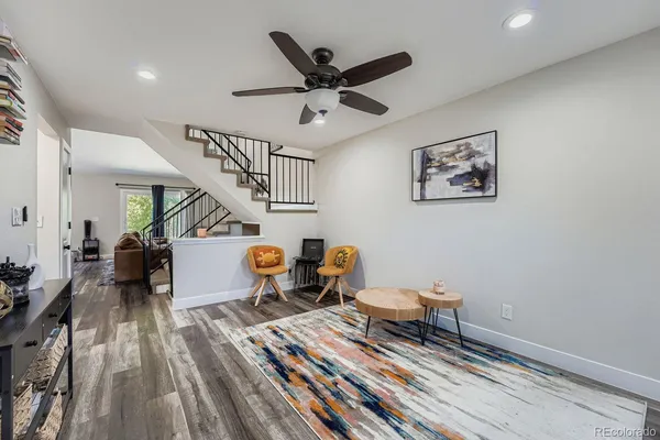 a living room with couch and a wooden floor