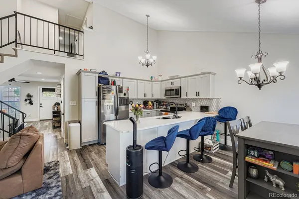 a view of kitchen center island dining table wooden floor and window
