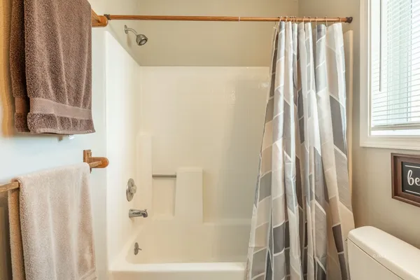 a bathroom with a shower curtain and a curtain