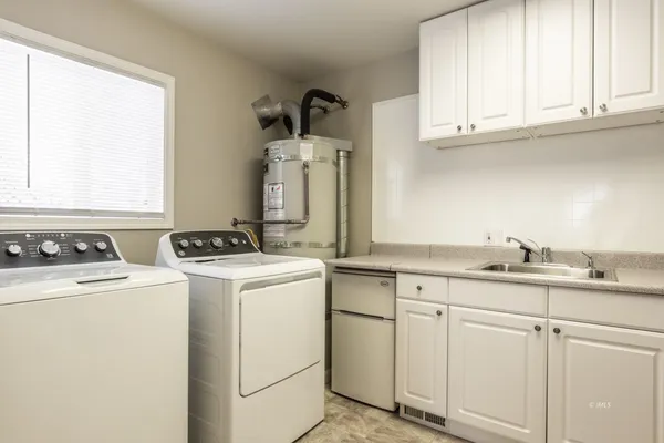 a kitchen with sink cabinets and appliances