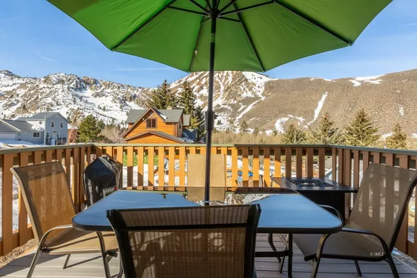a view of a balcony with chairs and an umbrella