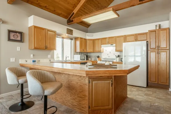 a kitchen with stainless steel appliances granite countertop a sink a stove and a refrigerator