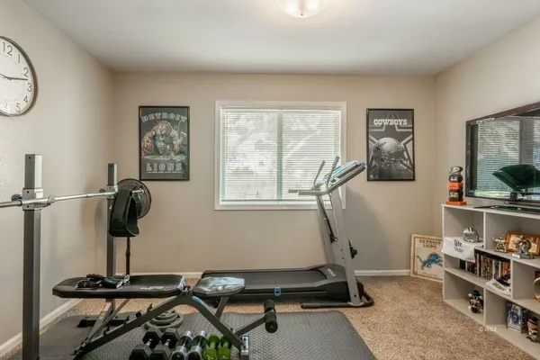 a room with gym equipment and a window