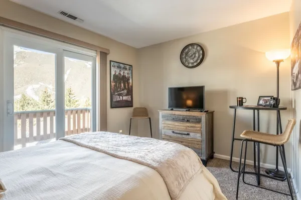 a bedroom with a bed and a flat screen tv