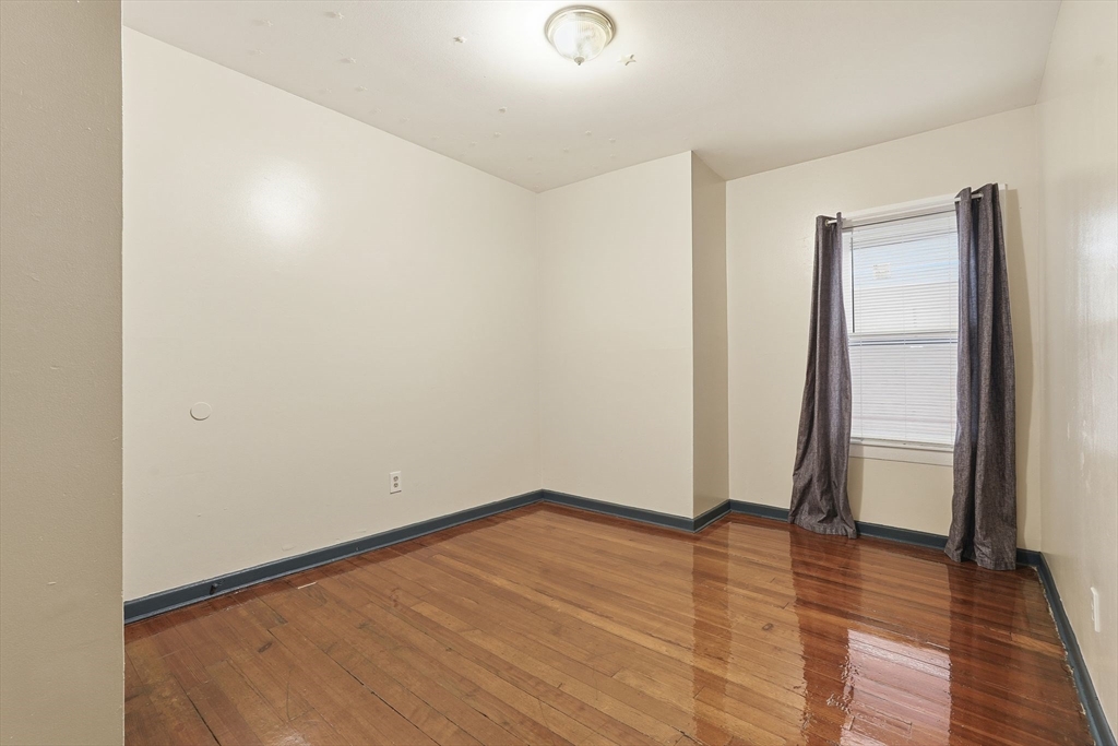 50-52 Maynard Street Springfield, MA 01109 - Photo 17 of 33 an empty room with wooden floor and entrance
