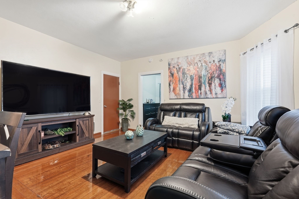 50-52 Maynard Street Springfield, MA 01109 - Photo 22 of 33 a living room with furniture and a flat screen tv