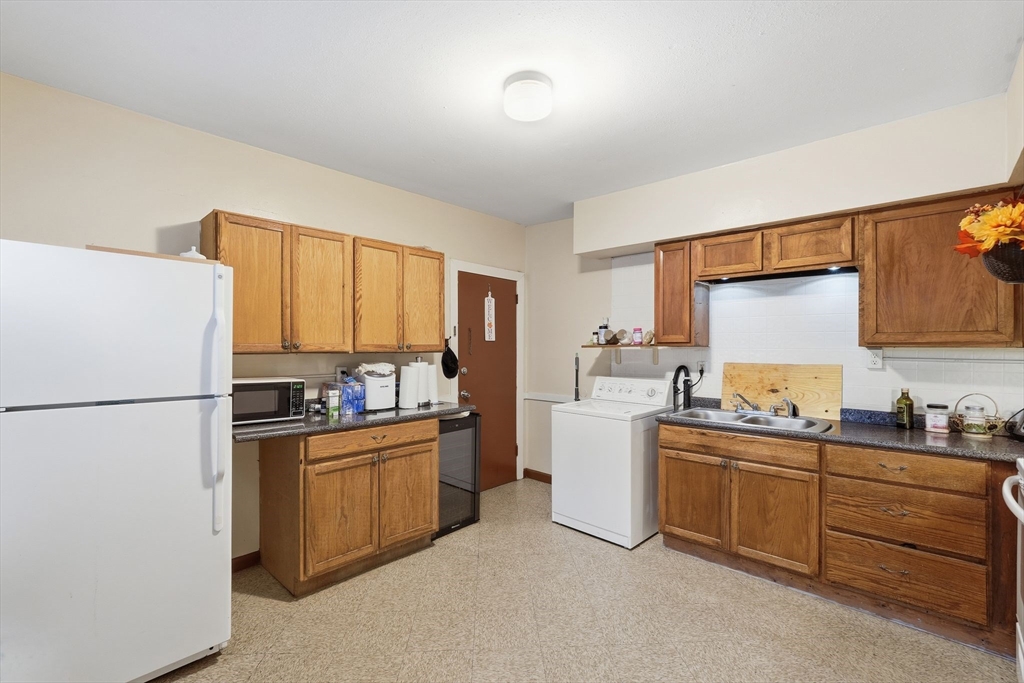 50-52 Maynard Street Springfield, MA 01109 - Photo 23 of 33 a kitchen with a sink stove and refrigerator