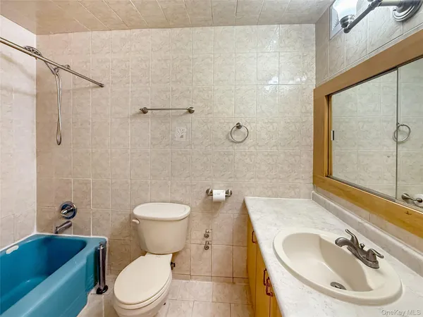 a bathroom with a toilet a sink and shower