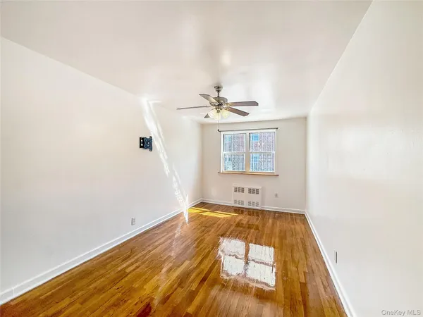 a view of a room with wooden floor and cabinet