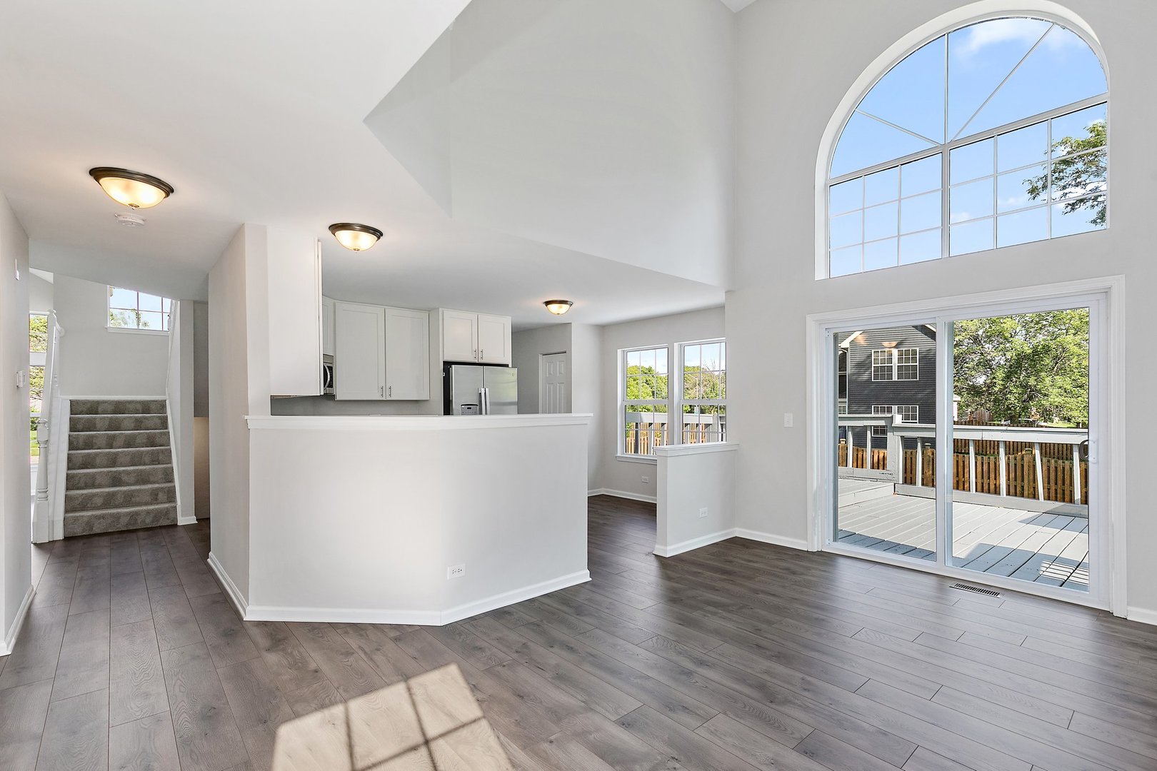 240 Penny Lane Bolingbrook, IL 60440 - Photo 11 of 22 a view of a living room a kitchen with furniture and wooden floor