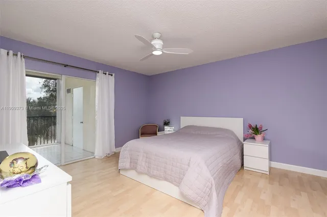 a bedroom with a bed dresser and a window