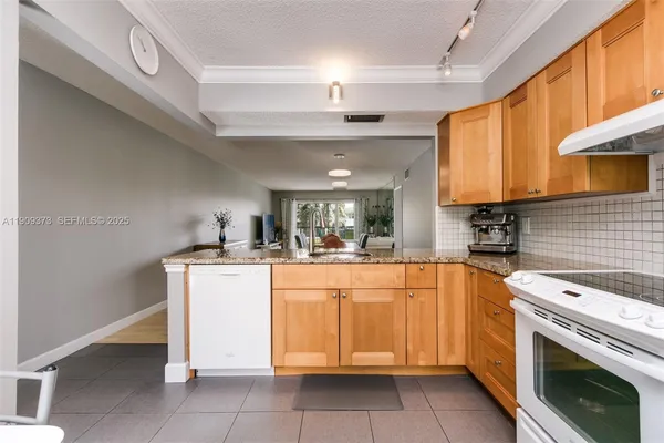 a kitchen with stainless steel appliances granite countertop a sink and cabinets
